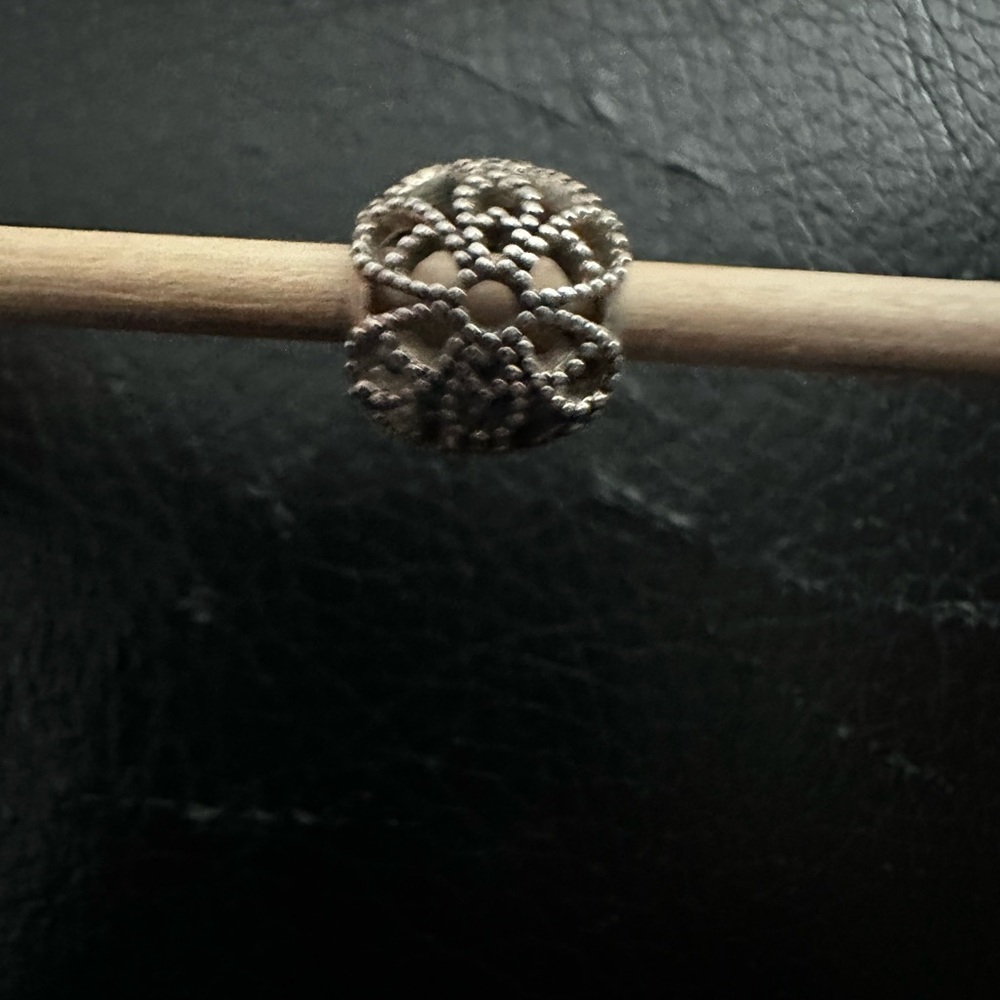 Authentic retired Pandora charm. “Fiore” open work charm.